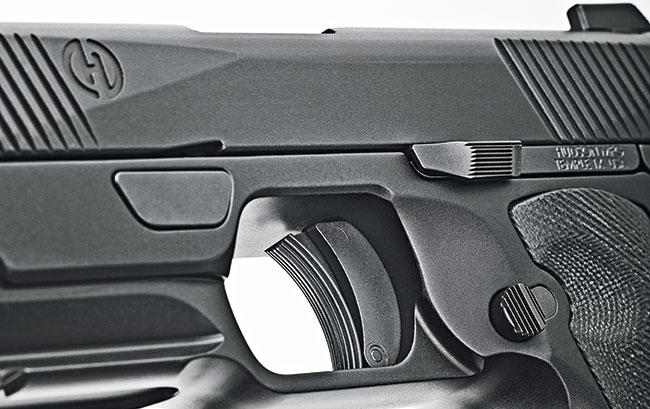 The controls are all in their expected places. However, the takedown plate is that trapezoid push-button rotating lever located above and forward of the 1911-ish trigger.