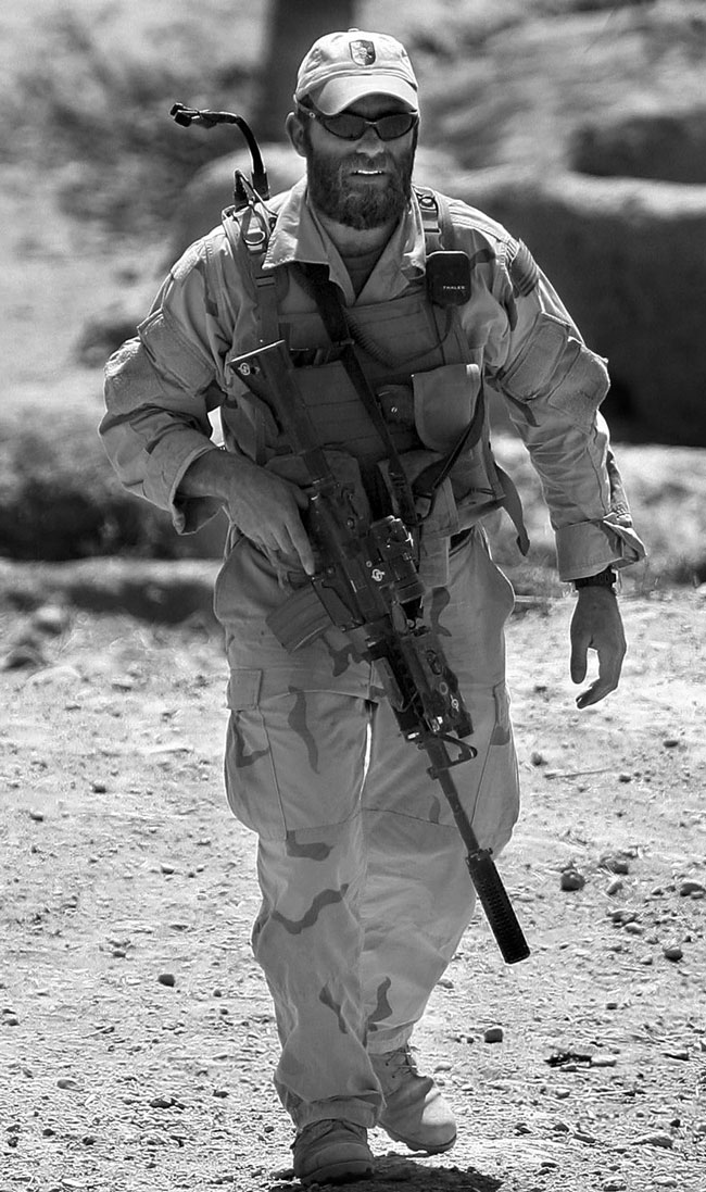 Captain Beckstrand conducting a patrol in Afghanistan in 2004, complete with his SOPMOD M4A1, equipped with an Aimpoint COMP M2 red dot sight.